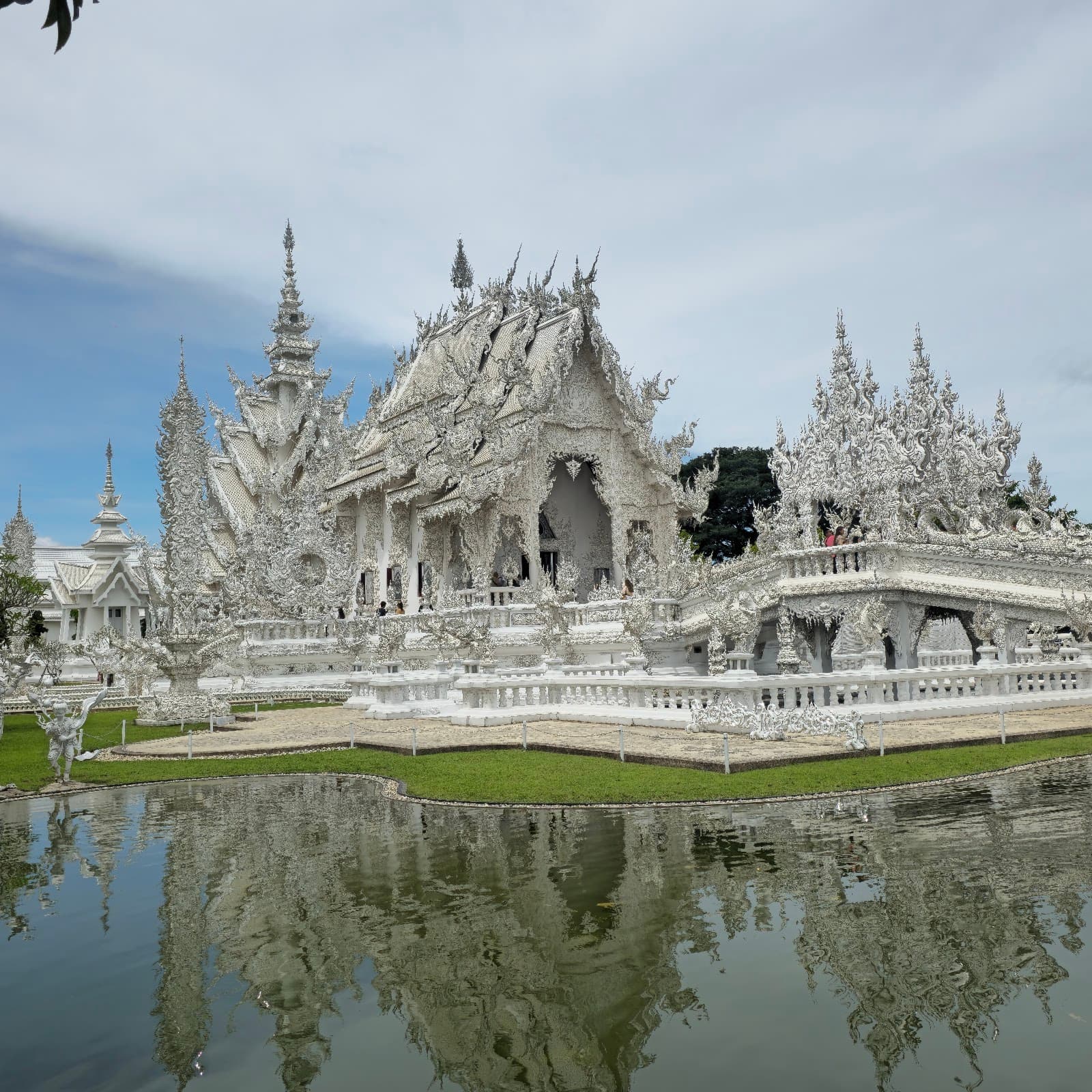 Iconic White Temple with water reflection in Chiang Rai.